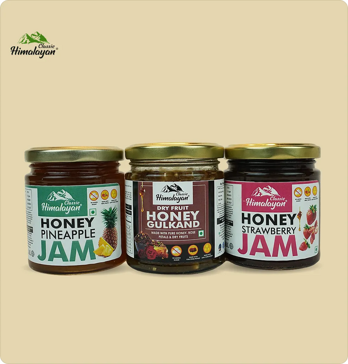 Three glass jars of Himalayan honey jams: Honey Pineapple Jam, Honey Gulkand, and Honey Strawberry Jam.