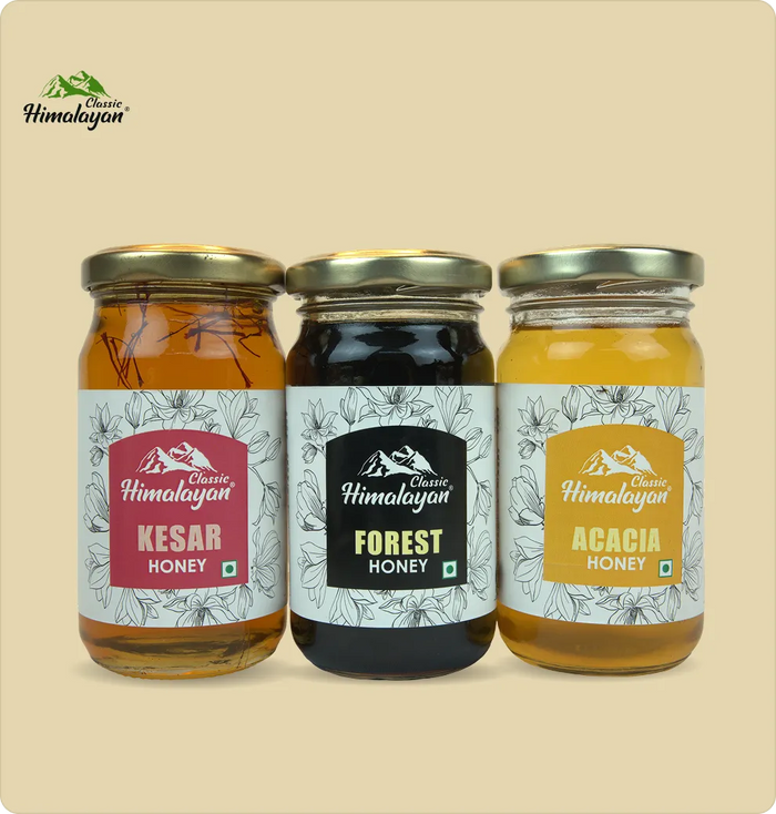 Three glass jars of Himalayan honey arranged as Kesar Honey, Forest Honey, and Acacia Honey.