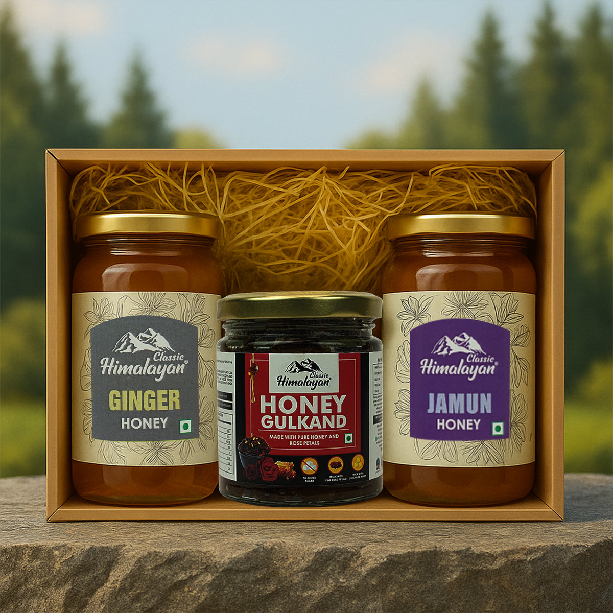 Three jars of honey labeled 'Ginger Honey', 'Honey Gulkand', and 'Jamun Honey' in a wooden box with a natural background.