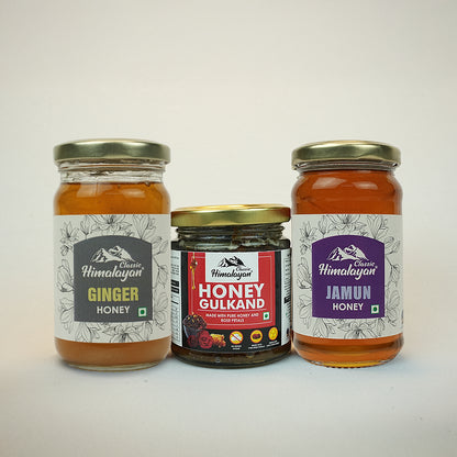 Three jars of honey with labels on a white background