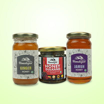 Three jars of honey with labels on a light green background